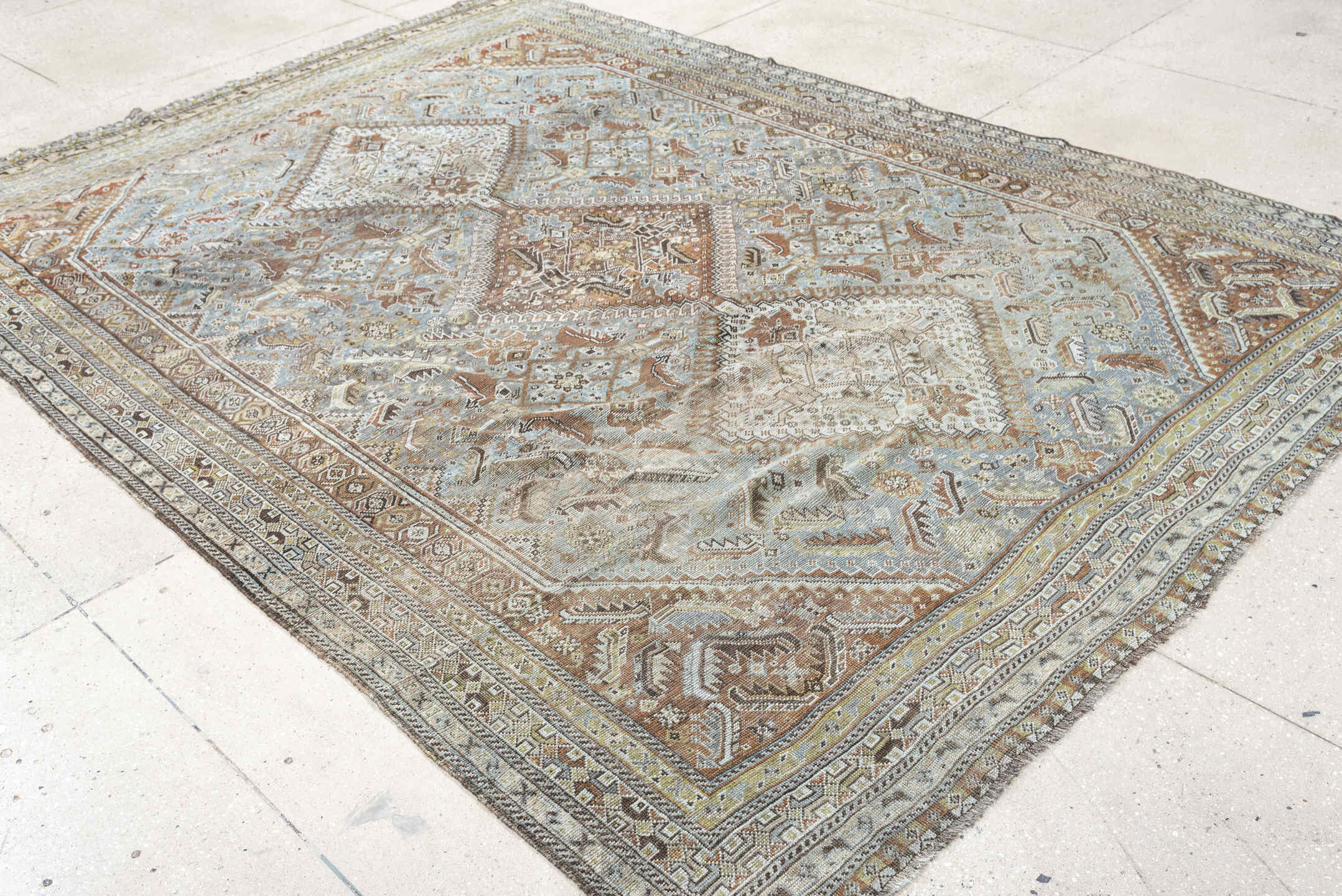 6' x 9' one-of-a-kind handmade antique Shiraz rug. Color palette: light blue, ivory, taupe, rust, brown, gold, camel