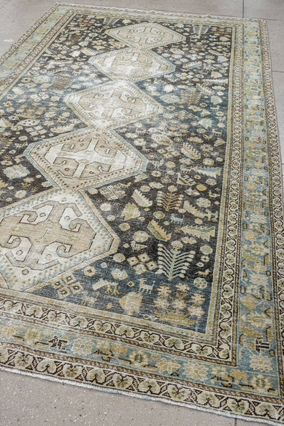 5' x 9' one-of-a-kind handmade antique Qashqai medium size rug. Color palette: charcoal, ivory, sky blue, taupe, beige