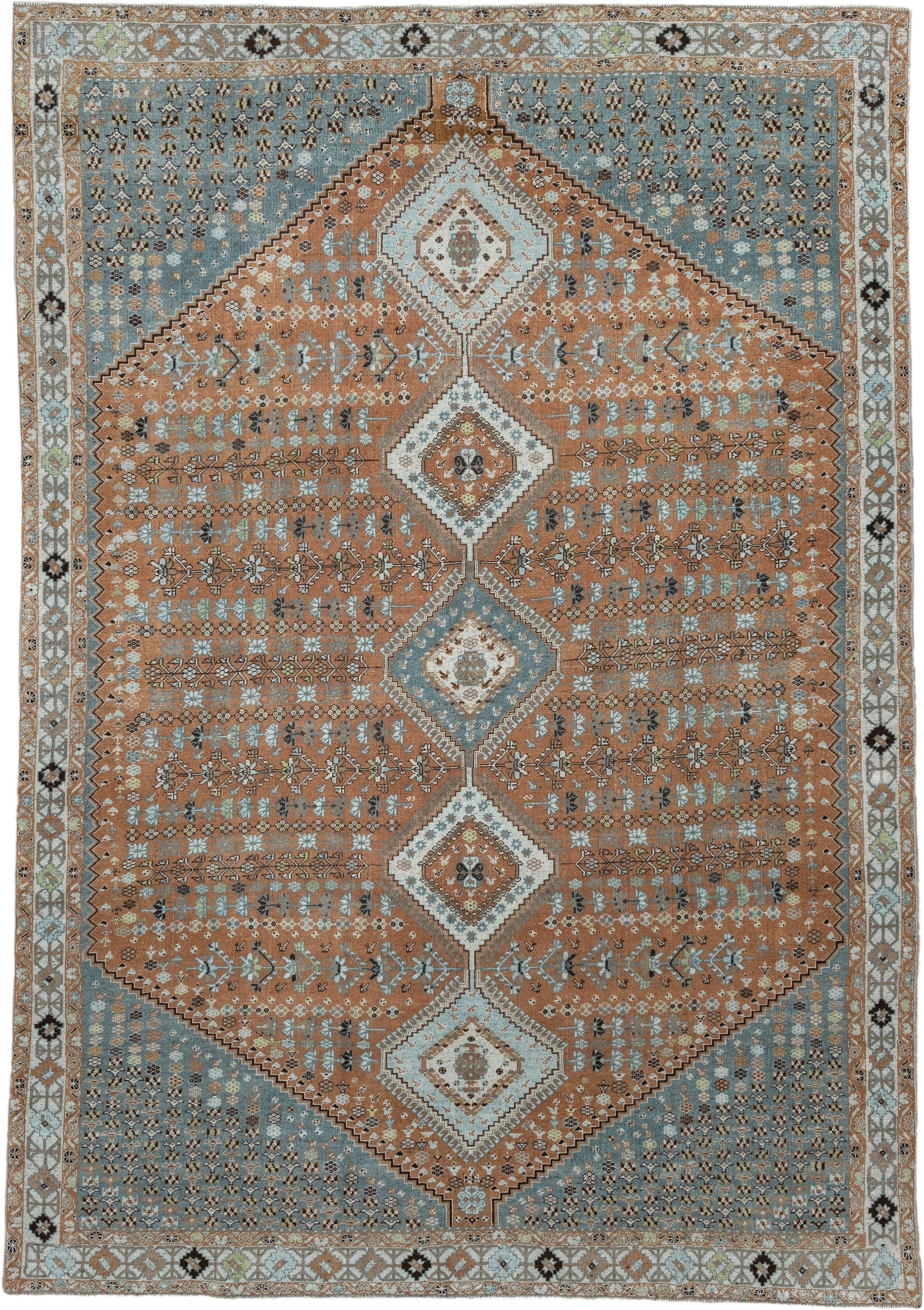 6' x 9' one-of-a-kind handmade antique Shiraz rug. Color palette: terra cotta, sky blue, ivory, camel, charcoal, sage, taupe