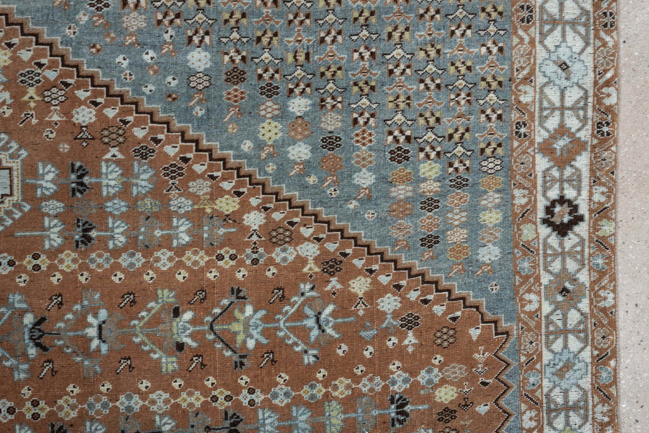 6' x 9' one-of-a-kind handmade antique Shiraz rug. Color palette: terra cotta, sky blue, ivory, camel, charcoal, sage, taupe