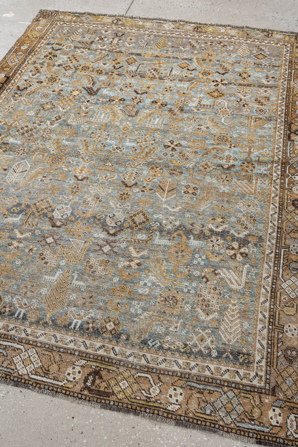 4' x 6' one-of-a-kind handmade antique Shiraz rug. Color palette: sky blue, camel, ivory, taupe, brown, slate, gold