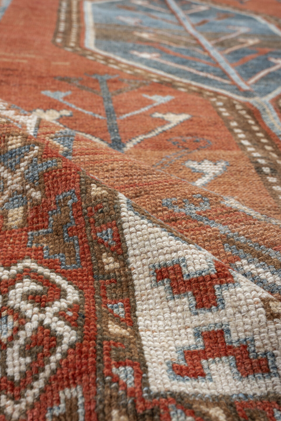 5' x 9' one-of-a-kind handmade antique Kurd medium size rug. Color palette: terra cotta, ivory, sky blue, brown, slate, rust