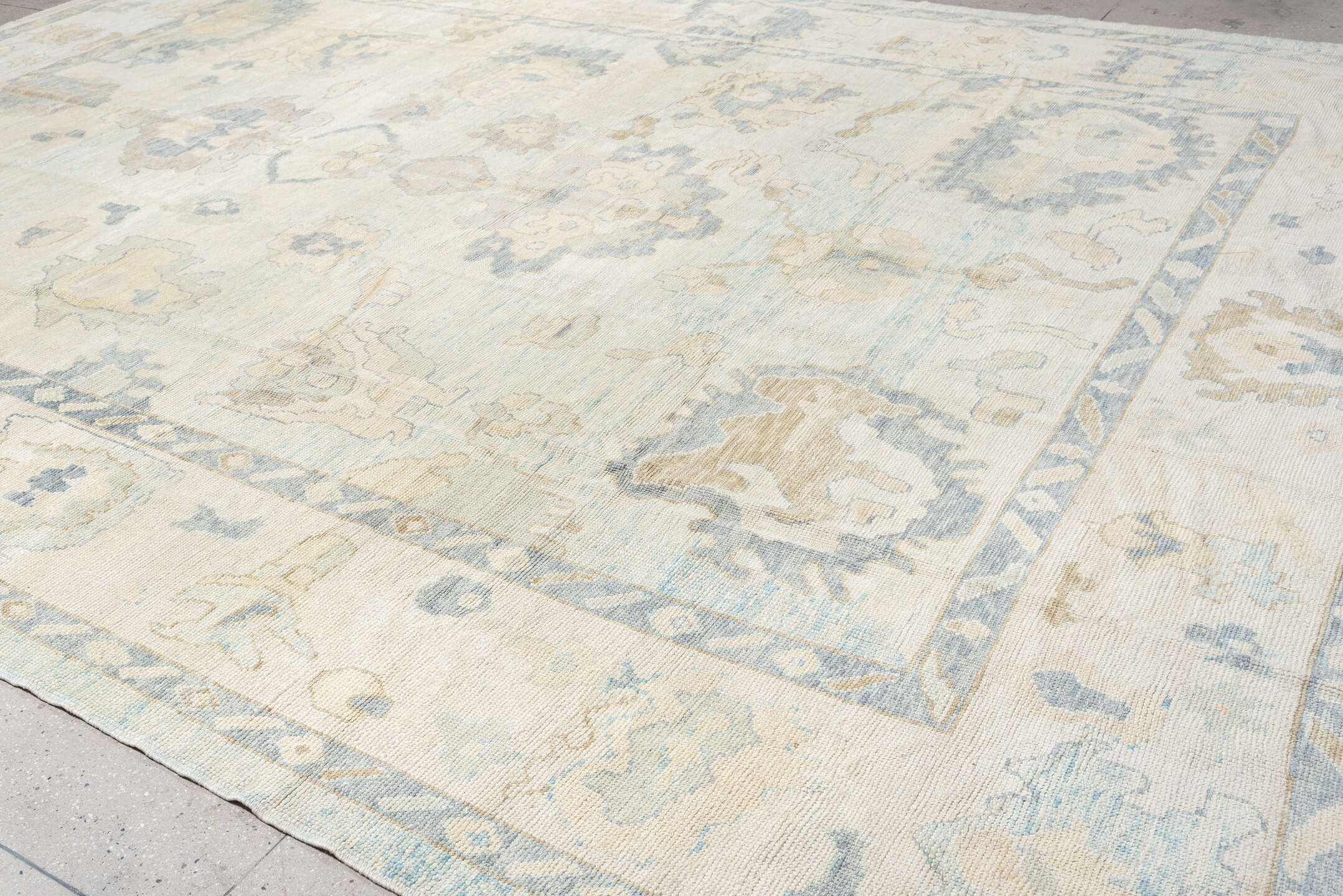12' x 17' one-of-a-kind handmade vintage Oushak oversize rug. Color palette: ivory, pale blue, beige, taupe, cream, sage