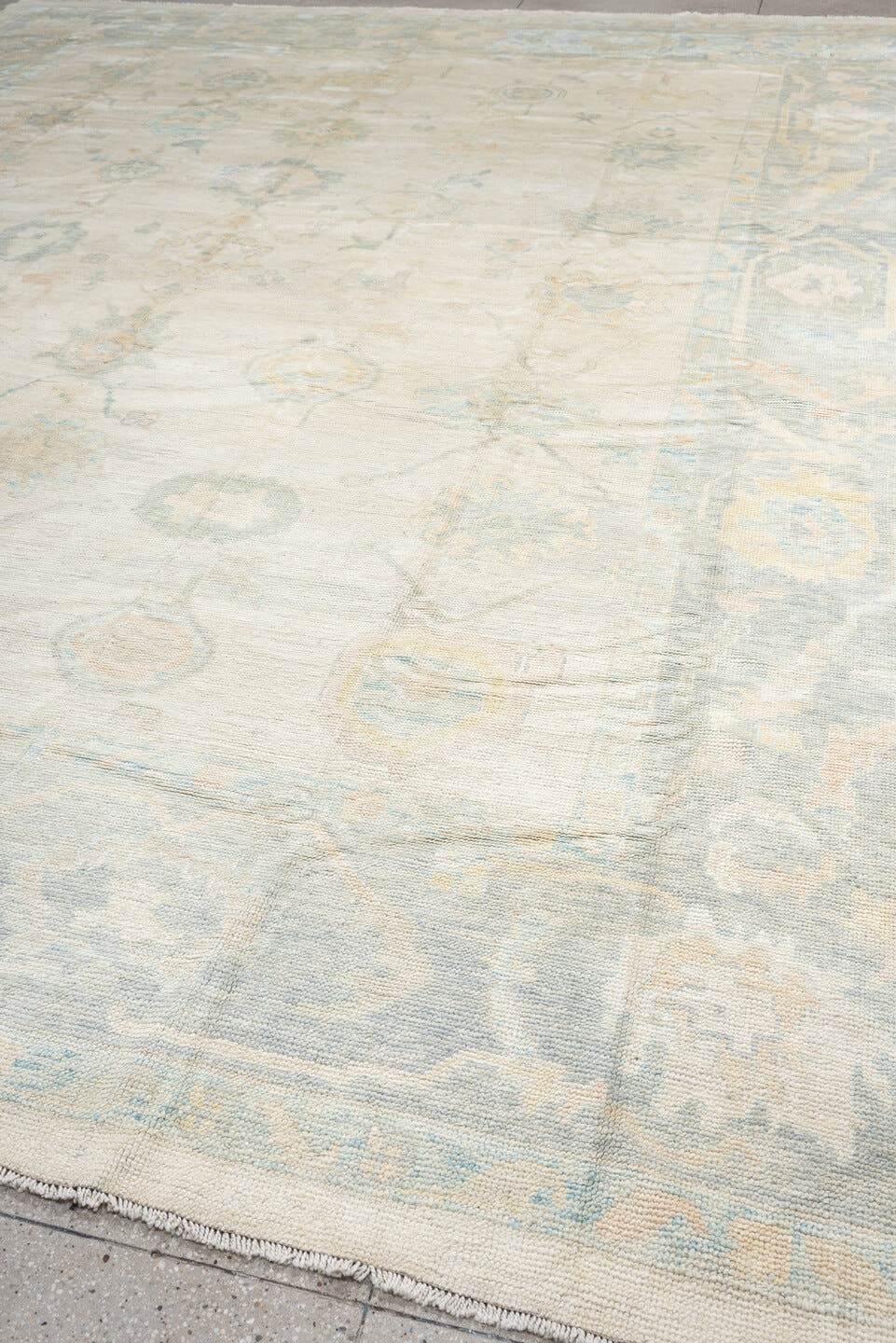 12' x 16' one-of-a-kind handmade vintage Oushak oversize rug. Color palette: ivory, pale blue, cream, taupe, blush, sage