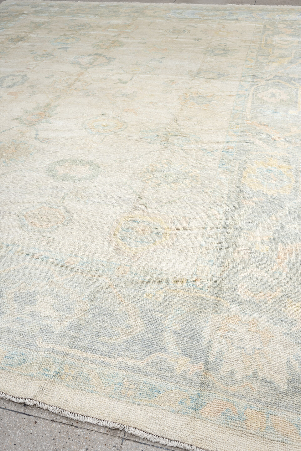 12' x 16' one-of-a-kind handmade vintage Oushak oversize rug. Color palette: ivory, pale blue, cream, taupe, blush, sage
