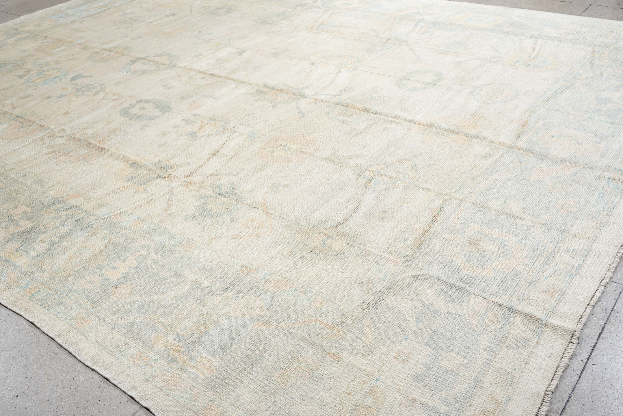12' x 16' one-of-a-kind handmade vintage Oushak oversize rug. Color palette: ivory, pale blue, cream, taupe, blush, sage