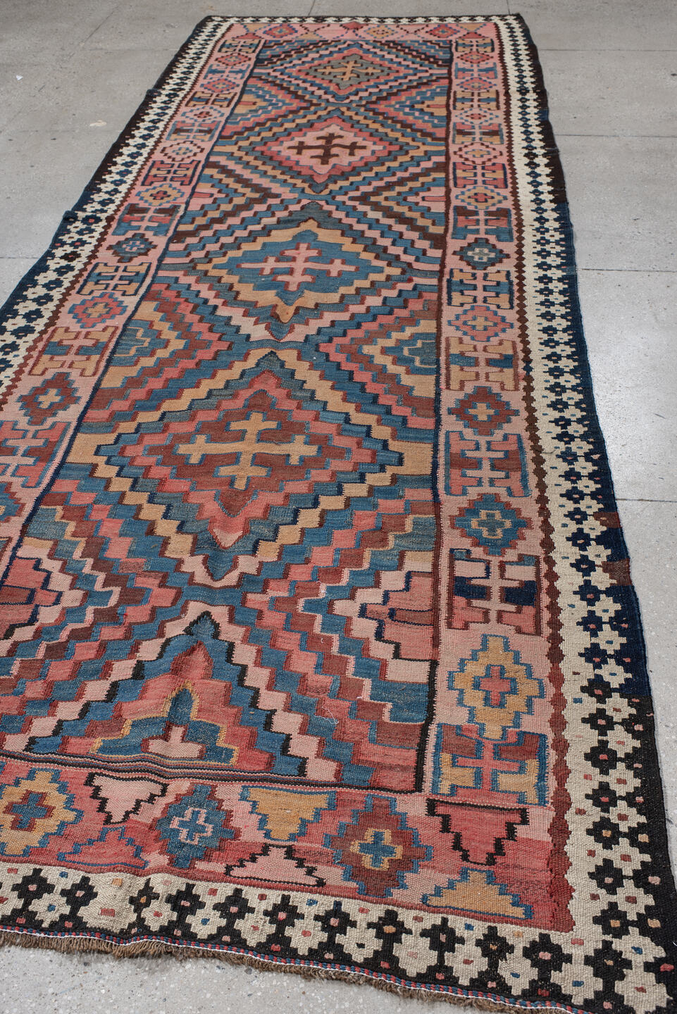 5' x 14' one-of-a-kind handmade vintage Kilim runner rug. Color palette: rose, indigo, ivory, rust, teal, camel, charcoal