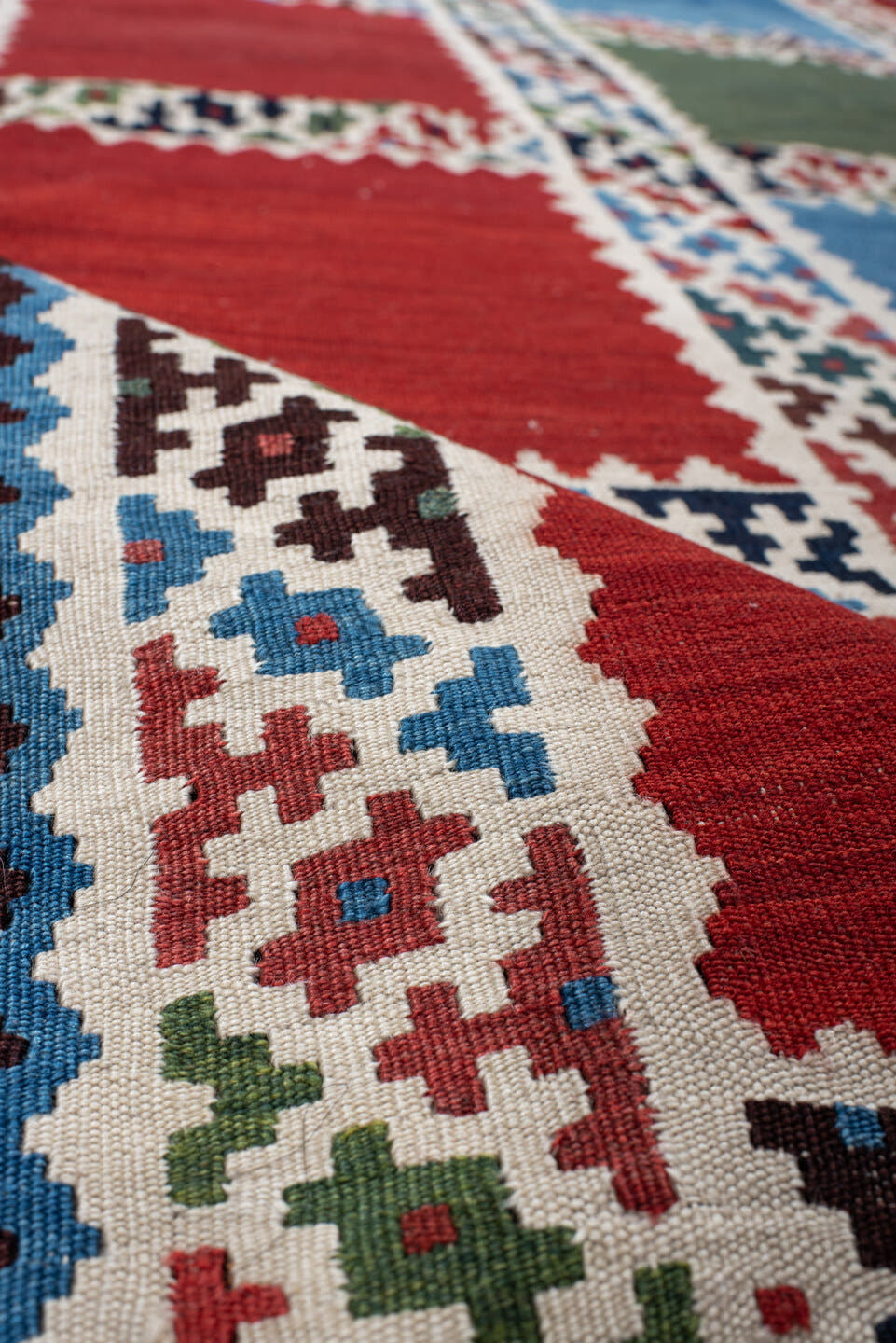5' x 7' one-of-a-kind handmade vintage Kilim rug. Color palette: rust, ivory, navy, sky_blue, olive, red, teal, brown