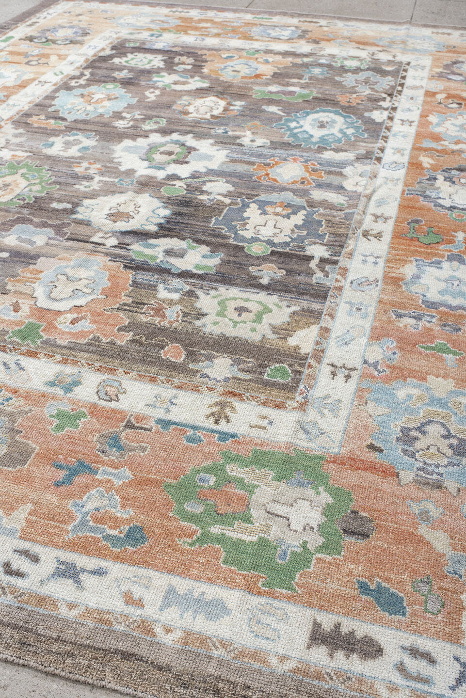 9' x 11' one-of-a-kind handmade vintage Oushak large size rug. Color palette: charcoal, apricot, ivory, sky blue, sage
