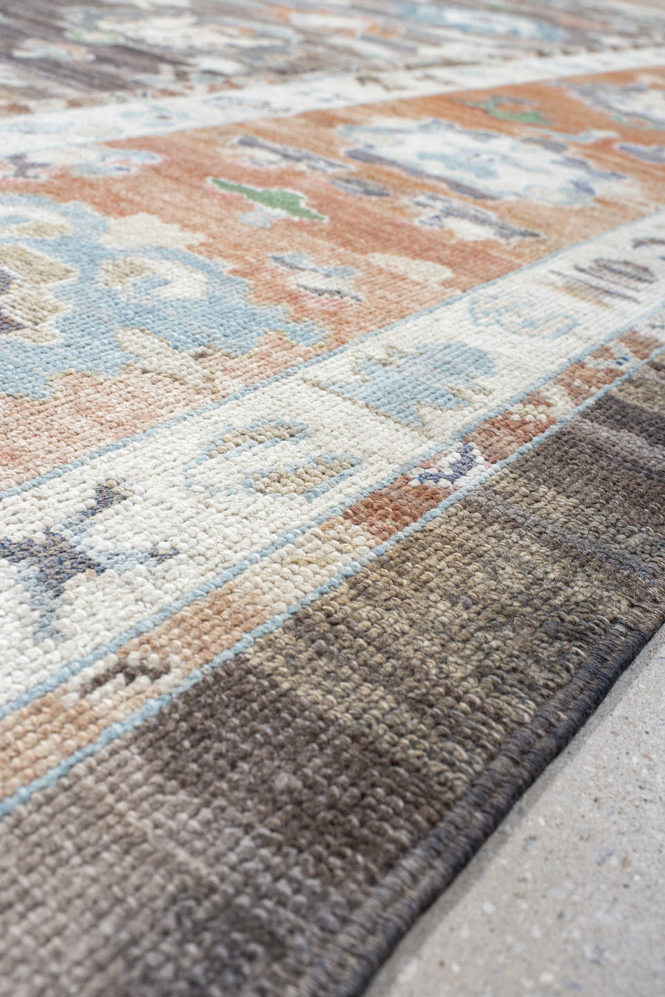 9' x 11' one-of-a-kind handmade vintage Oushak large size rug. Color palette: charcoal, apricot, ivory, sky blue, sage