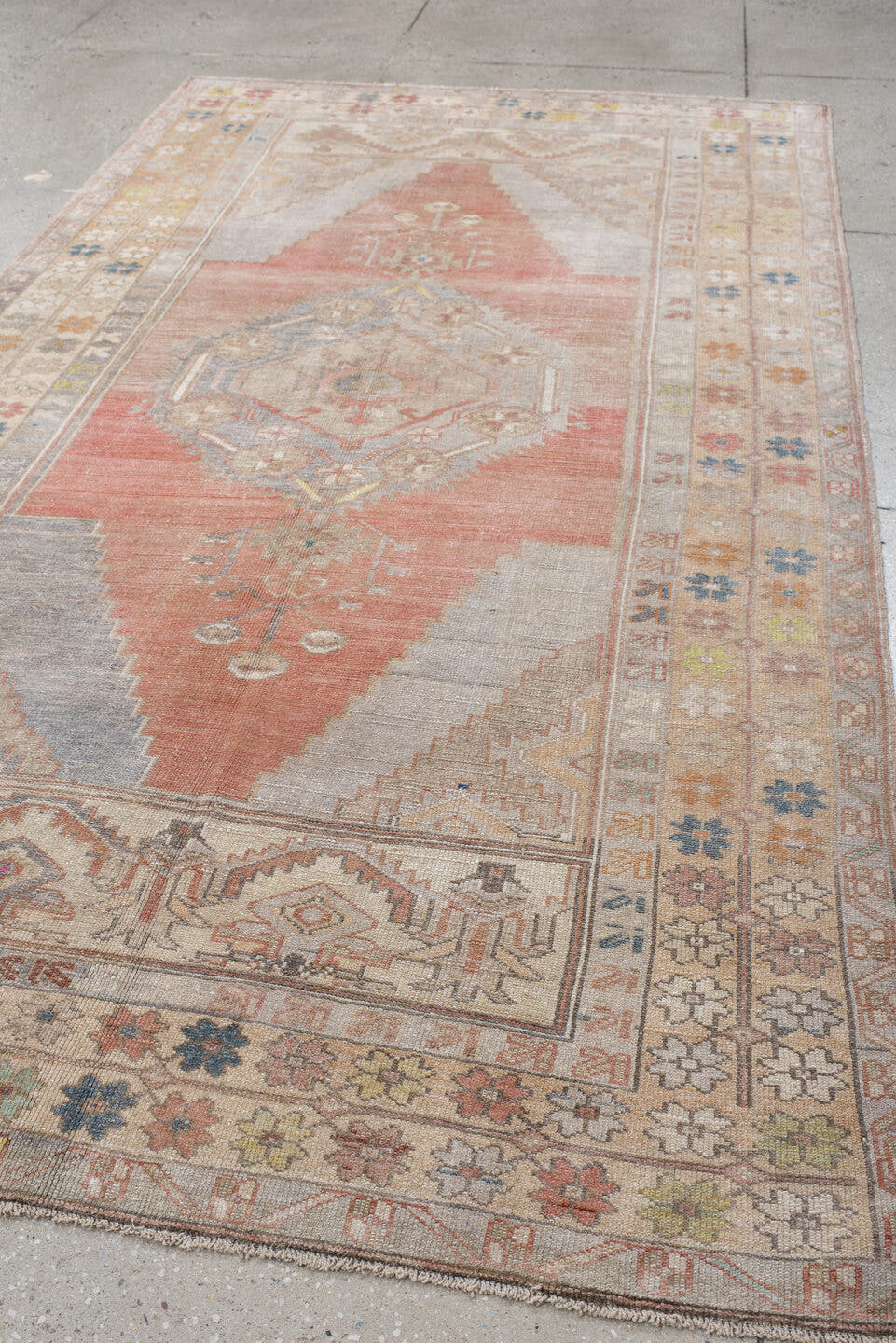 5' x 9' one-of-a-kind handmade antique Anatolian medium size rug. Color palette: ivory, coral, taupe, slate, sage, ochre