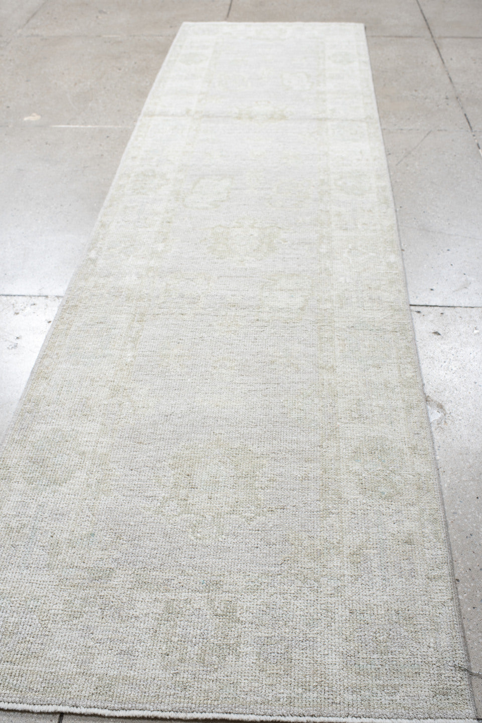 2' x 9' one-of-a-kind handmade antique Oushak runner rug. Color palette: ivory, cream, taupe, beige, pale sage, gray, green