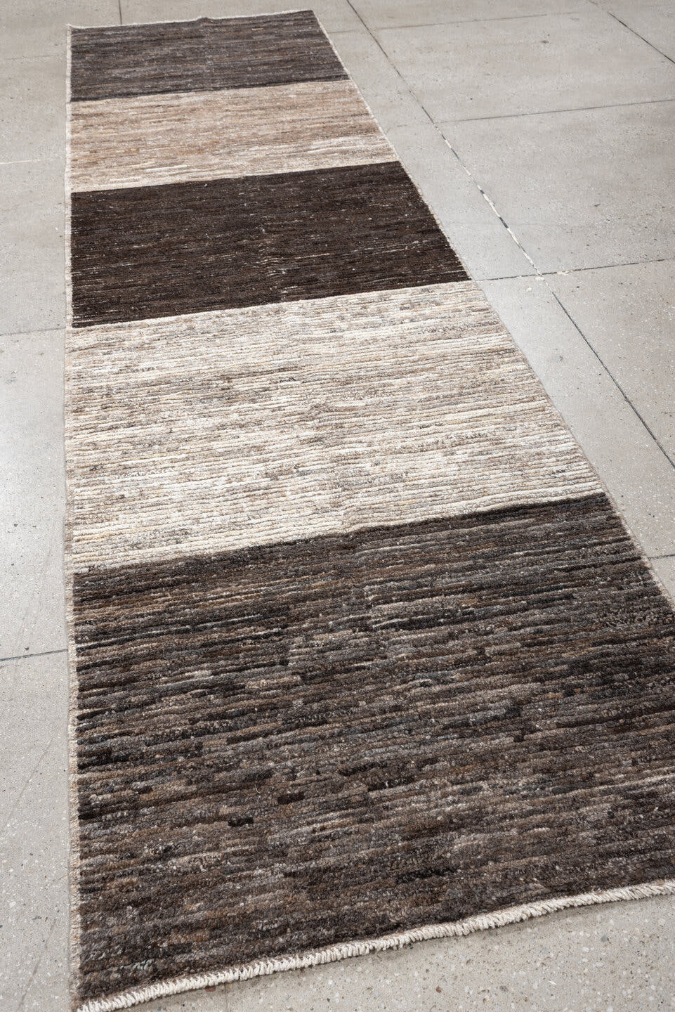 3' x 12' one-of-a-kind handmade vintage Tulu runner rug. Color palette: charcoal, taupe, ivory, brown, cream, slate, black