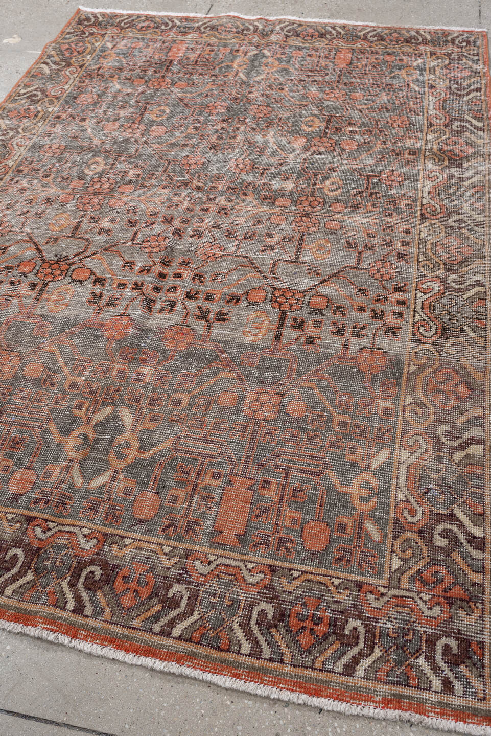 4' x 7' one-of-a-kind handmade antique rug. Color palette: charcoal, coral, ivory, taupe, slate, terra cotta, brown, black