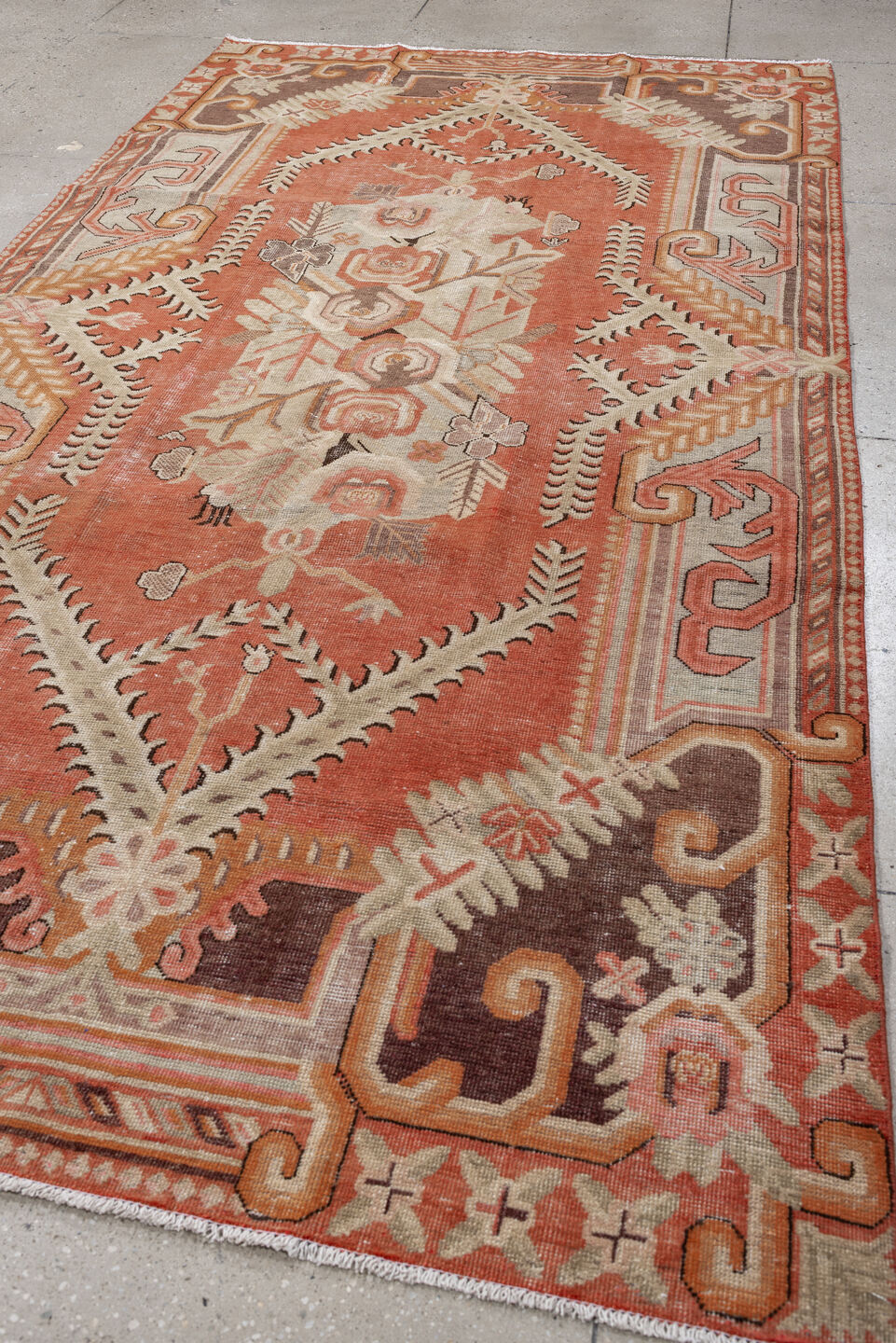 5' x 10' one-of-a-kind handmade antique Khotan large size rug. Color palette: coral, ivory, taupe, chocolate_brown, peach