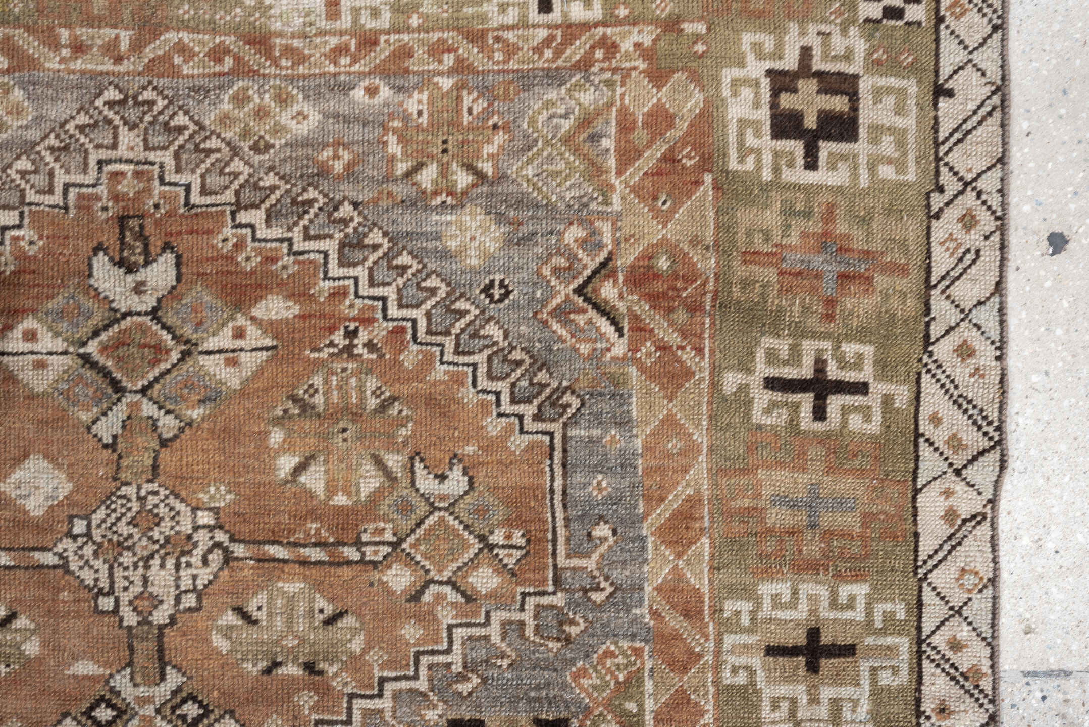 4' x 6' one-of-a-kind handmade antique Shiraz rug. Color palette: terra cotta, sage, ivory, charcoal, taupe, slate, camel