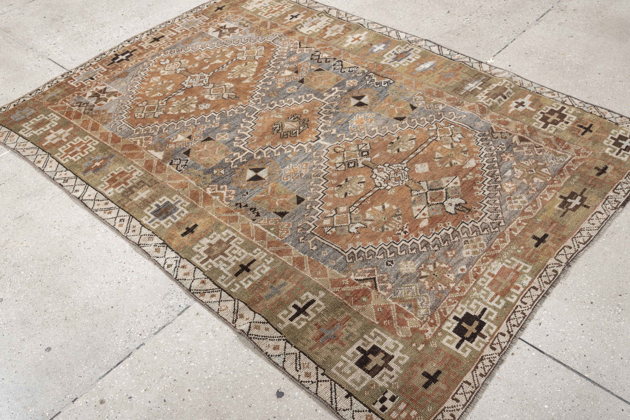 4' x 6' one-of-a-kind handmade antique Shiraz rug. Color palette: terra cotta, sage, ivory, charcoal, taupe, slate, camel