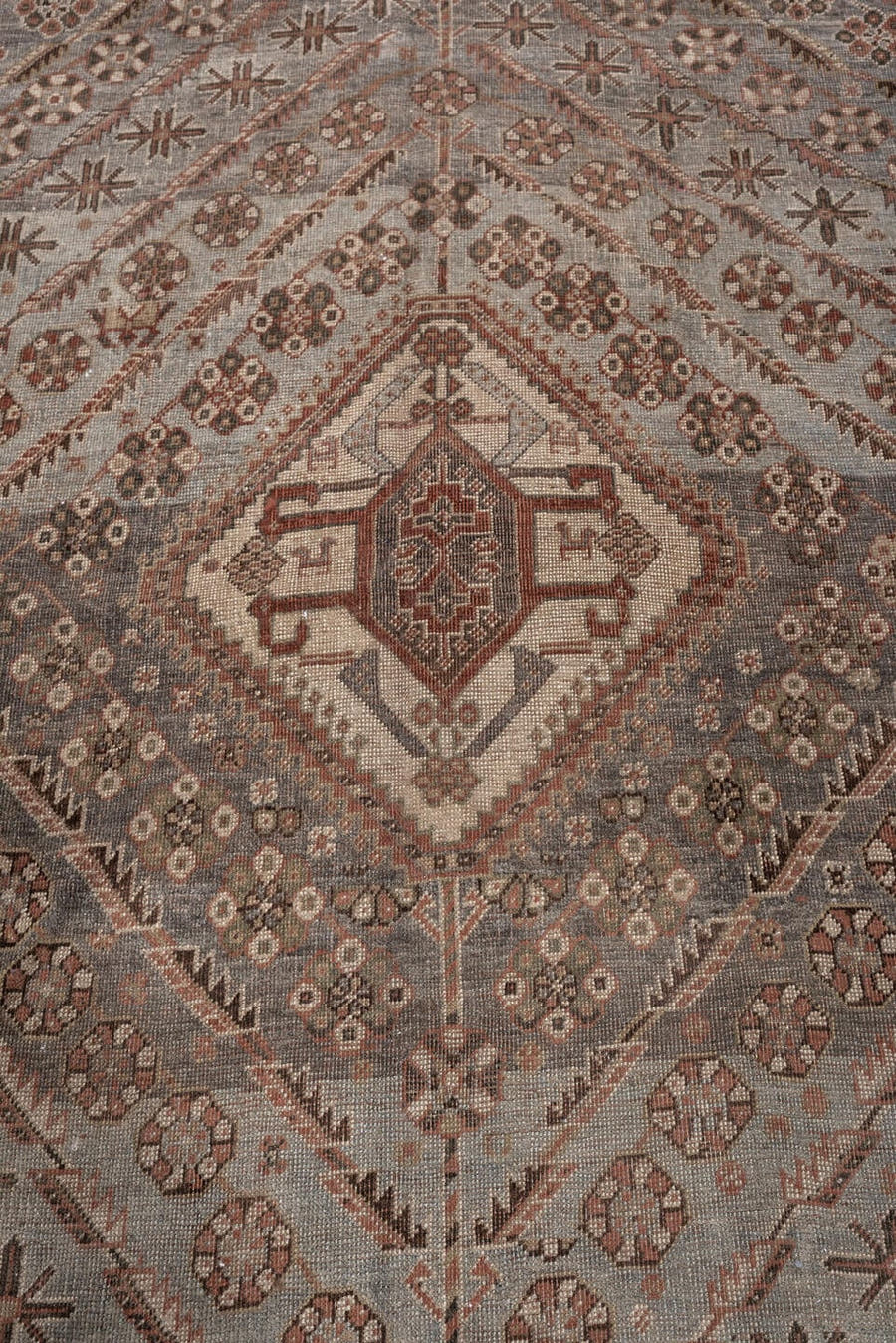 6' x 8' one-of-a-kind handmade antique Shiraz medium size rug. Color palette: rust, blue gray, ivory, taupe, charcoal