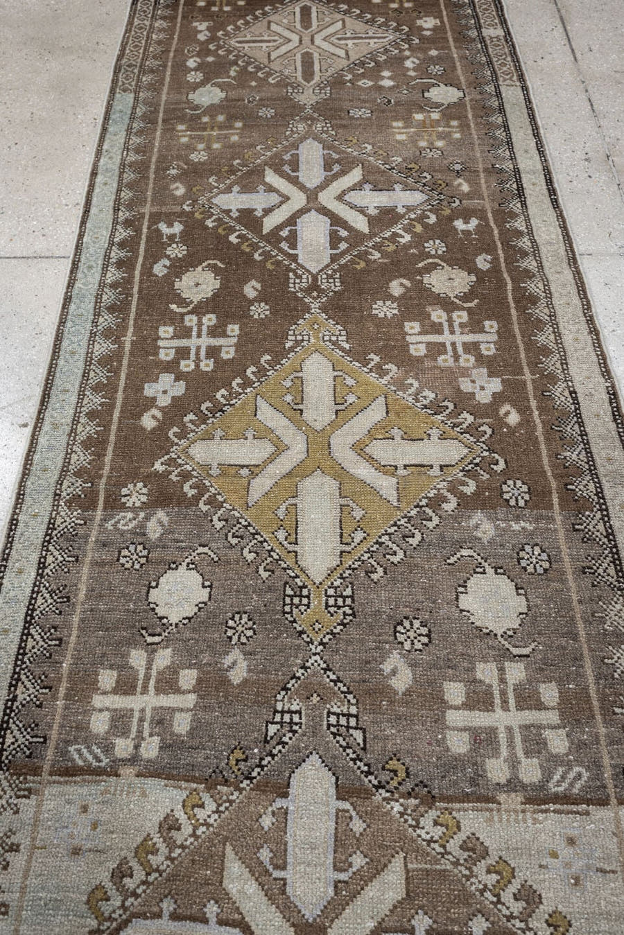 2' x 10' one-of-a-kind handmade antique Kurd runner rug. Color palette: taupe, ivory, camel, charcoal, brown, pale blue