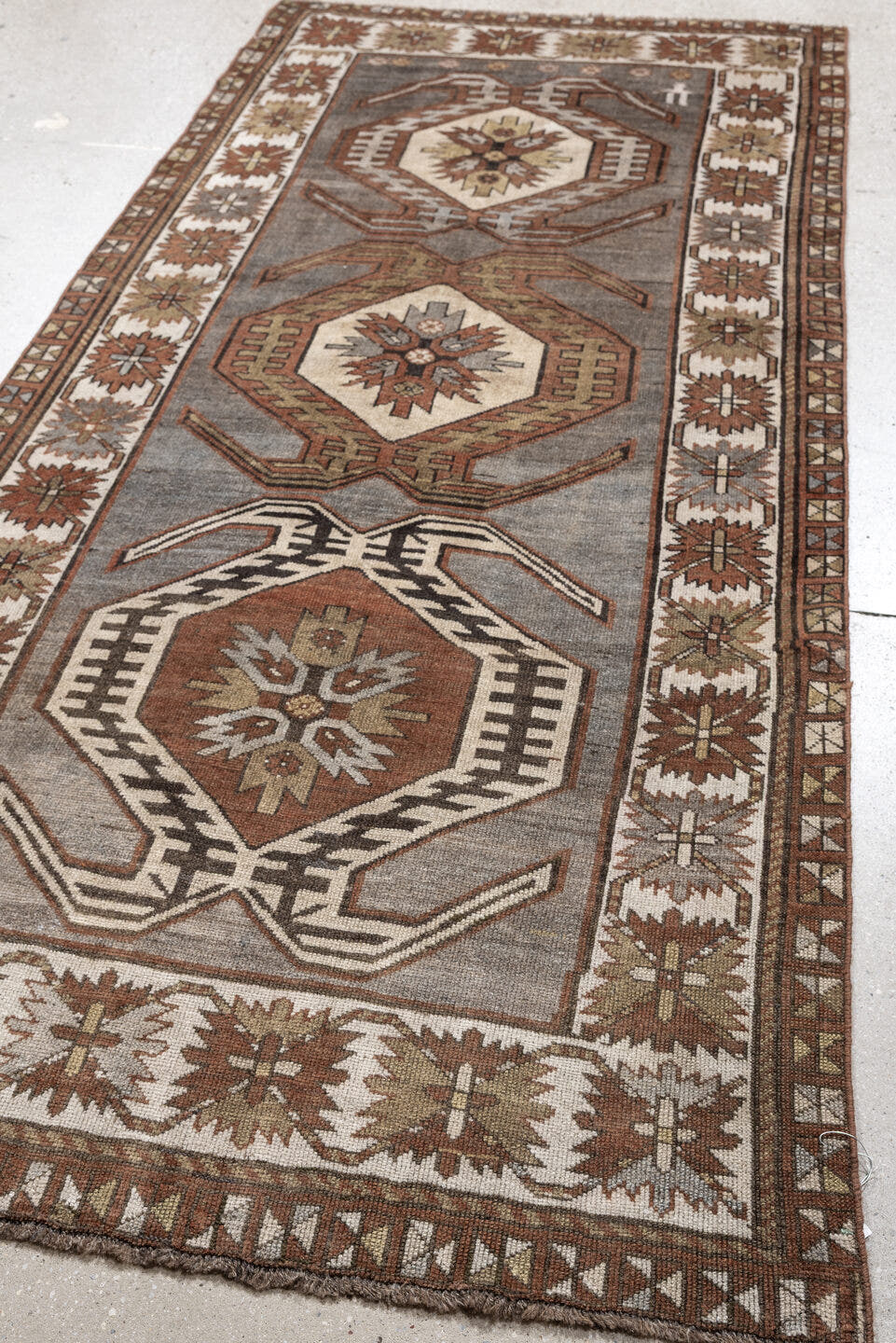 3' x 7' one-of-a-kind handmade antique Caucasian runner rug. Color palette: charcoal, ivory, rust, taupe, dark brown, camel