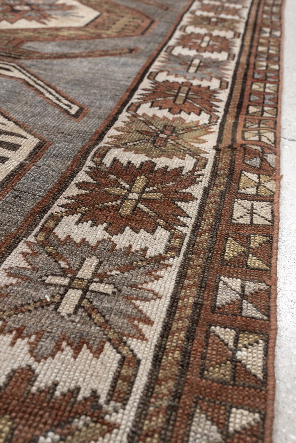 3' x 7' one-of-a-kind handmade antique Caucasian runner rug. Color palette: charcoal, ivory, rust, taupe, dark brown, camel