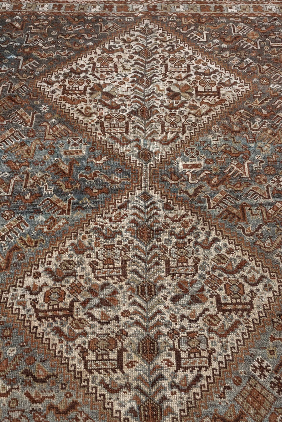 4' x 6' one-of-a-kind handmade antique Shiraz rug. Color palette: blue gray, ivory, rust, charcoal, taupe, terracotta, brown