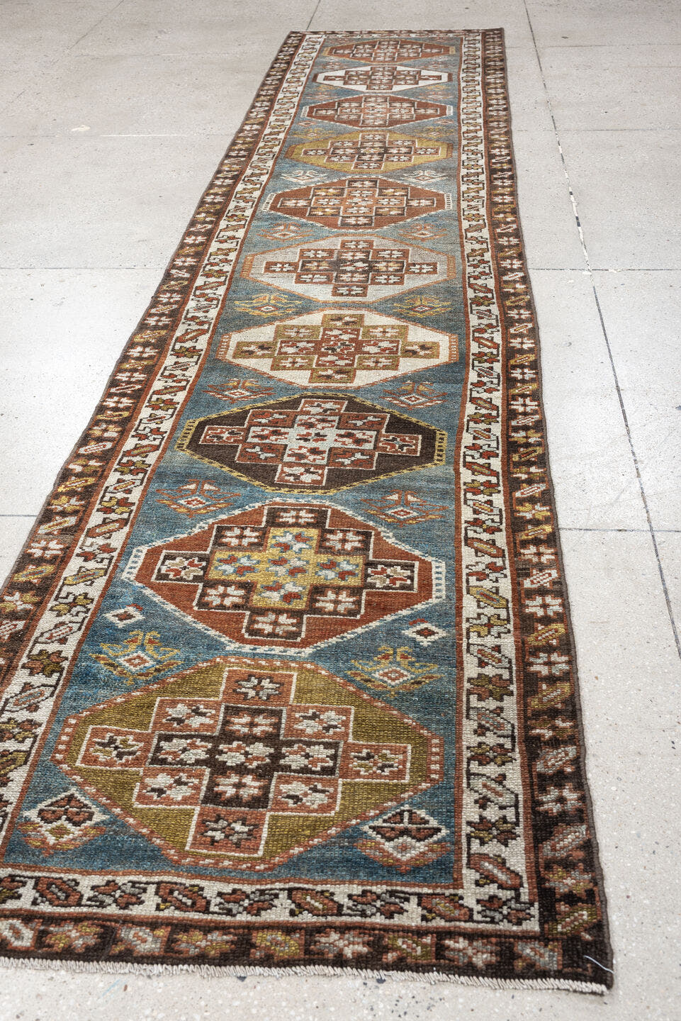 2' x 12' one-of-a-kind handmade antique Kurd runner rug. Color palette: blue green, rust, ivory, dark brown, ochre, olive