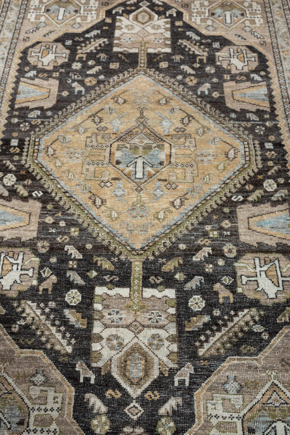 4' x 6' one-of-a-kind handmade antique Shiraz rug. Color palette: ivory, charcoal, camel, taupe, pale blue, olive, sand