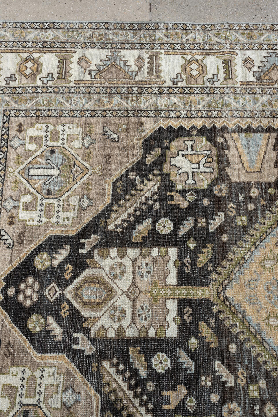 4' x 6' one-of-a-kind handmade antique Shiraz rug. Color palette: ivory, charcoal, camel, taupe, pale blue, olive, sand