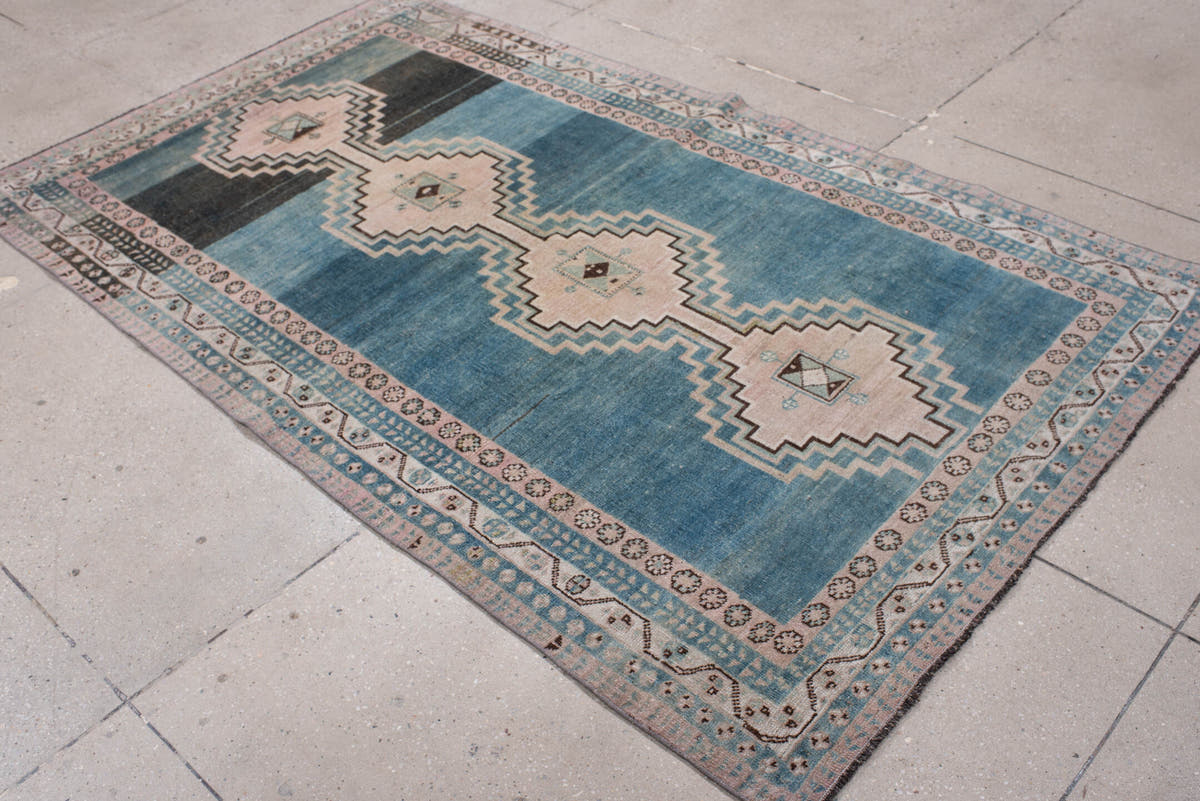 4' x 7' one-of-a-kind handmade antique Shiraz rug. Color palette: teal blue, ivory, blush, charcoal, slate blue, dark brown