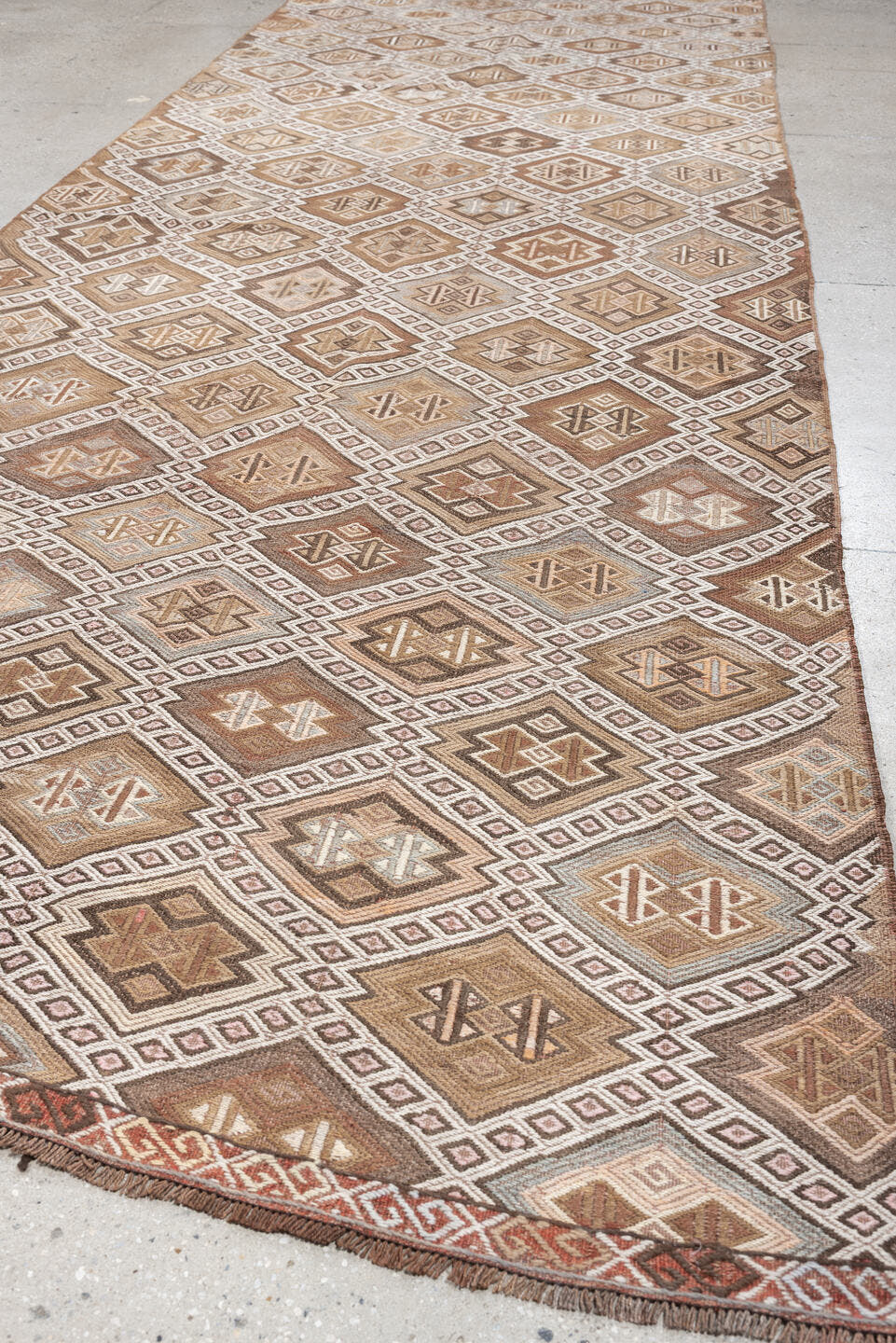 5' x 14' one-of-a-kind handmade antique Jijim rug. Color palette: taupe, ivory, camel, dusty rose, rust, brown, charcoal