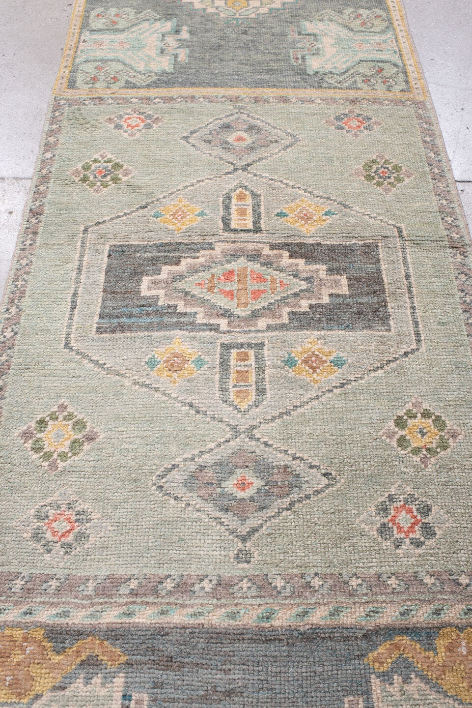 2' x 32' one-of-a-kind handmade vintage Oushak runner rug. Color palette: sage, aqua, ivory, terracotta, ochre, coral
