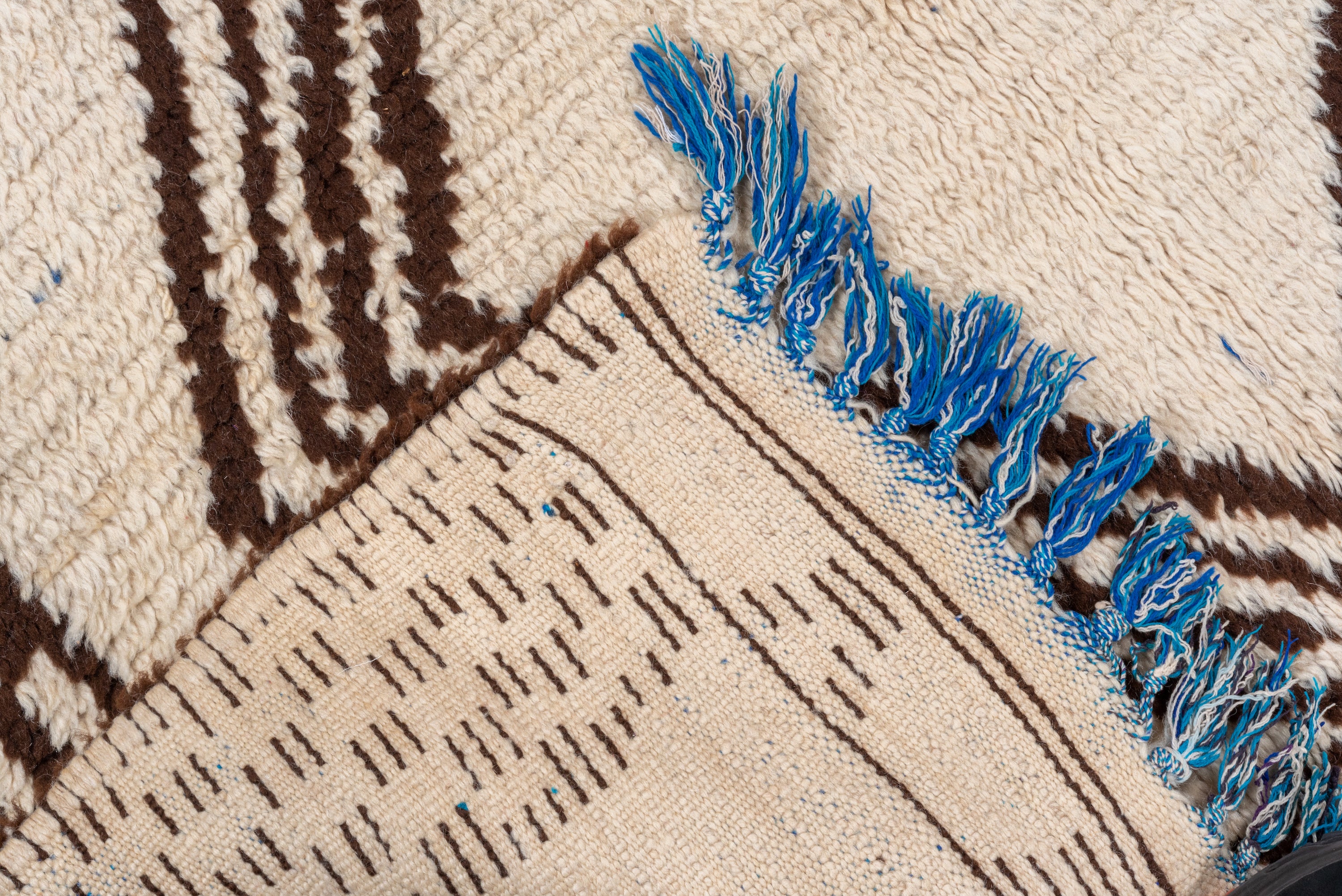 Cream and brown handmade vintage Moroccan runner rug with blue tassels