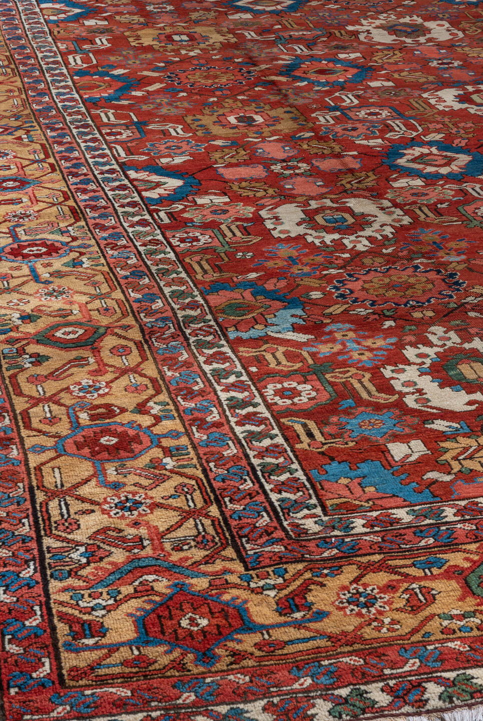 11' x 21' one-of-a-kind handmade antique Serapi oversize rug. Color palette: red, ivory, camel, blue, rose, rust, sage