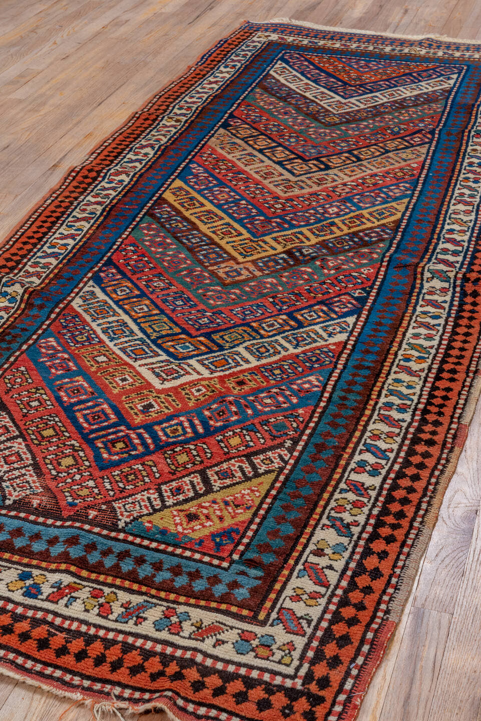 3' x 9' one-of-a-kind handmade vintage Genje runner rug. Color palette: rust, ivory, cobalt, navy, terra cotta, camel