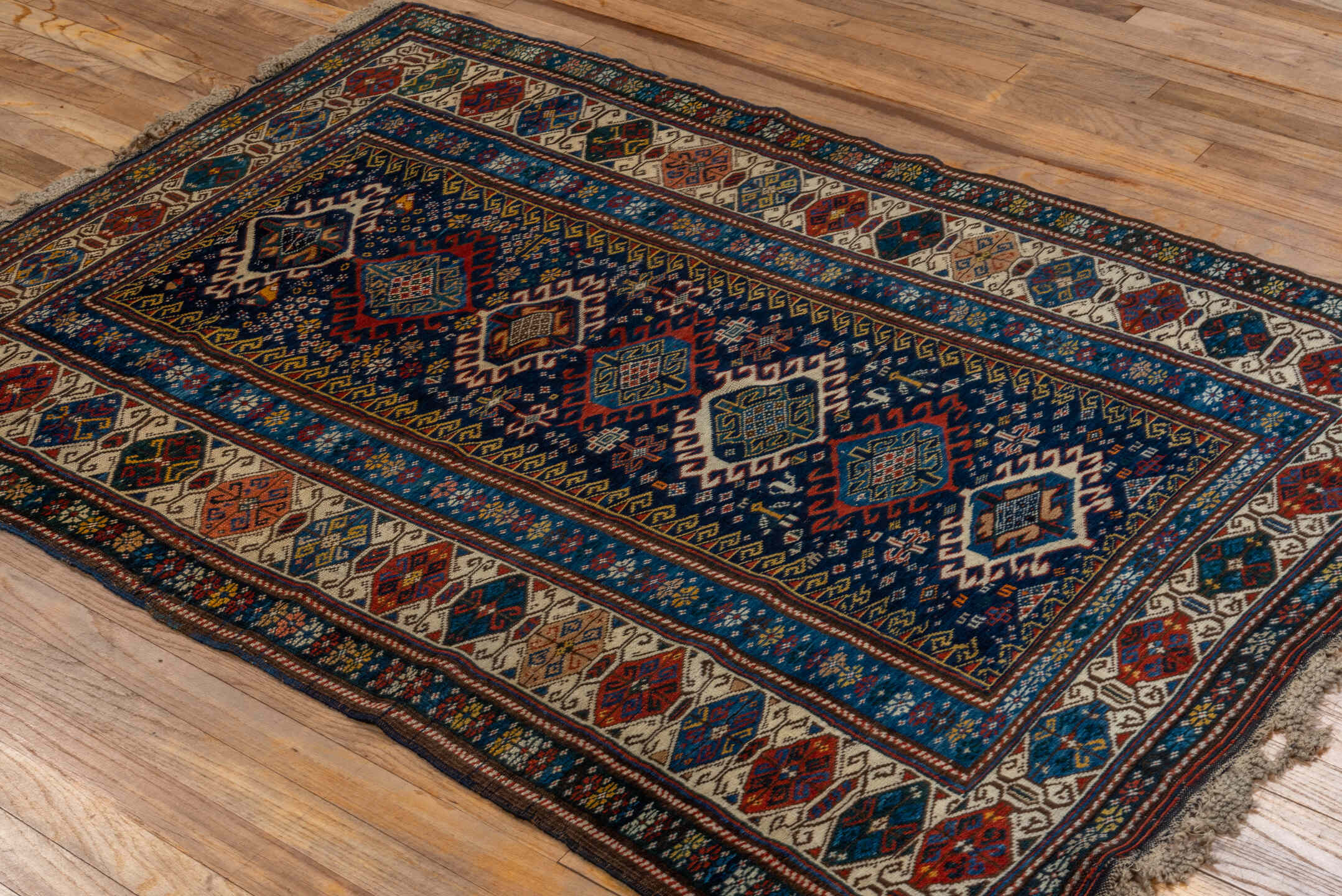 3' x 5' one-of-a-kind handmade vintage Shirvan small size rug. Color palette: navy, ivory, cobalt, crimson, rust, camel