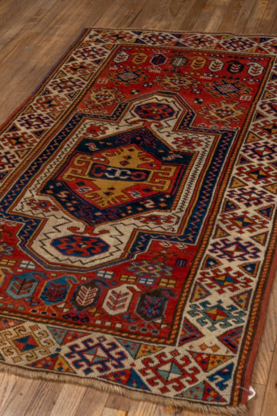 3' x 6' one-of-a-kind handmade vintage Kazak small size rug. Color palette: rust, ivory, navy, gold, crimson, camel, teal