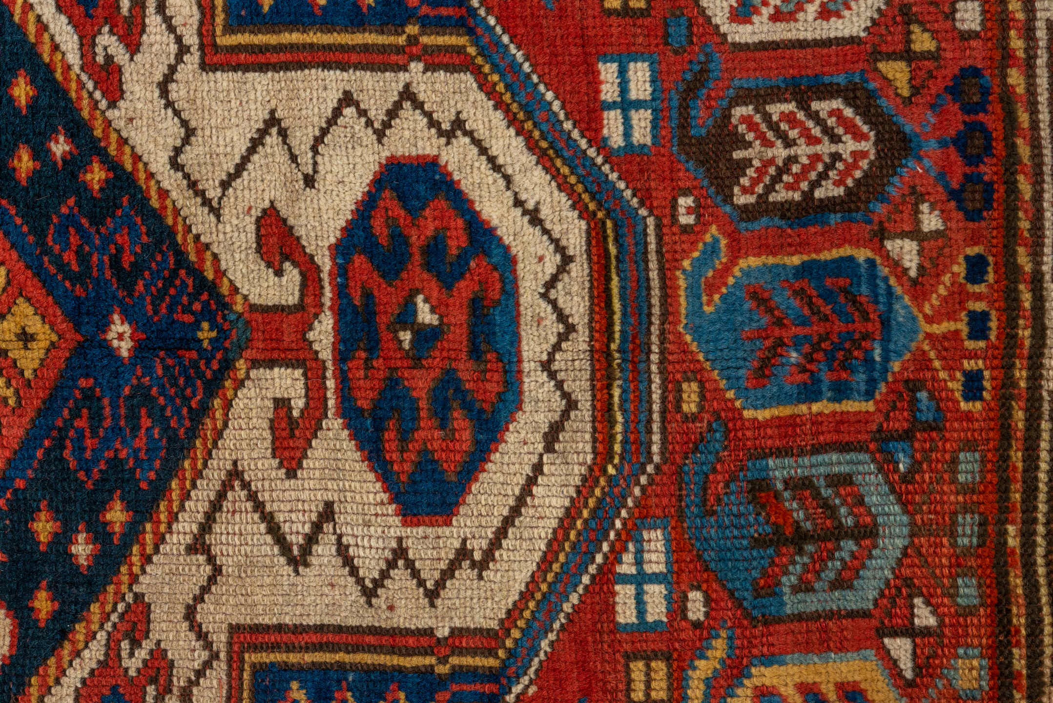 3' x 6' one-of-a-kind handmade vintage Kazak small size rug. Color palette: rust, ivory, navy, gold, crimson, camel, teal