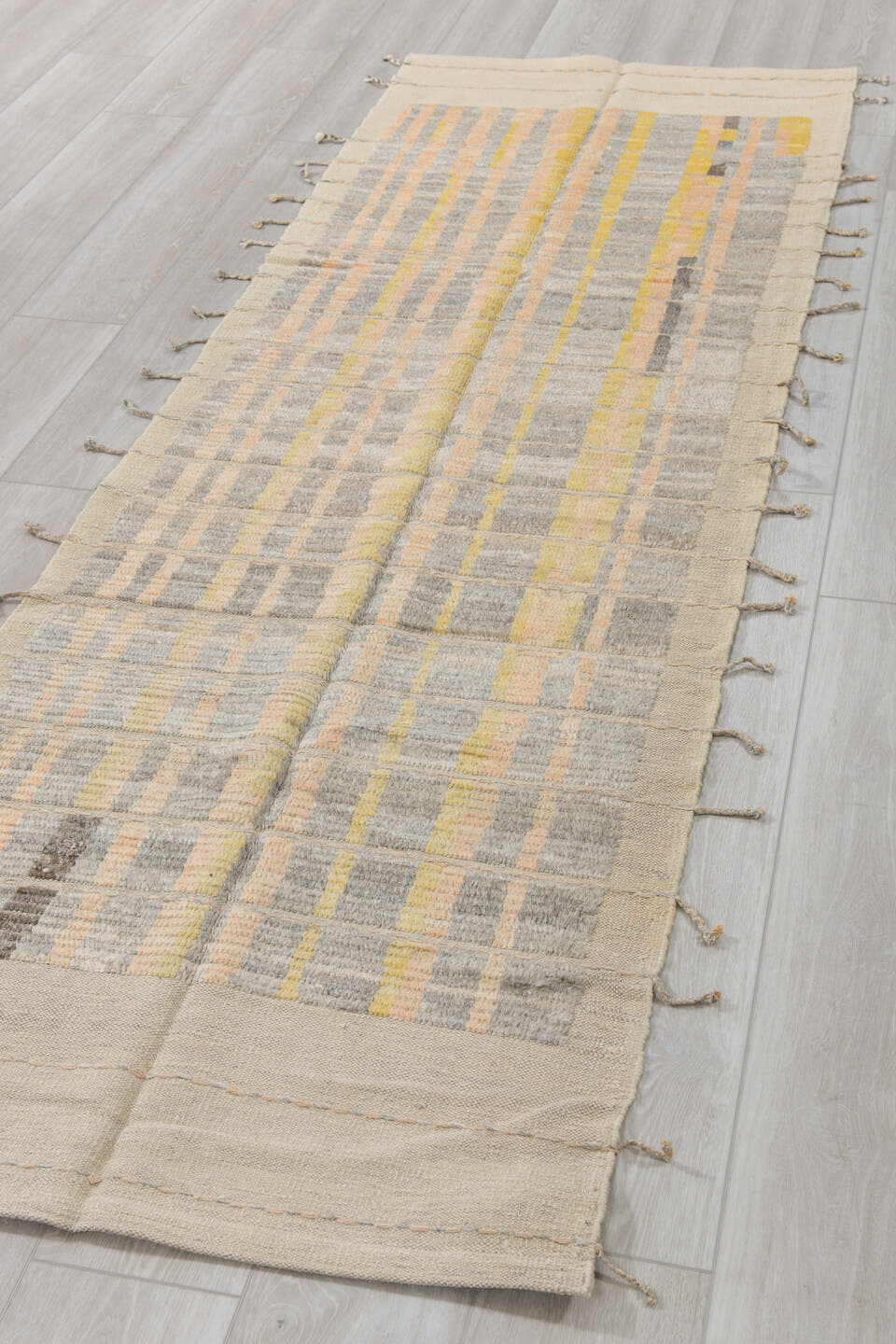 2' x 9' one-of-a-kind handmade vintage Tulu runner rug. Color palette: ivory, pale gold, gray, charcoal, cream, gold, black