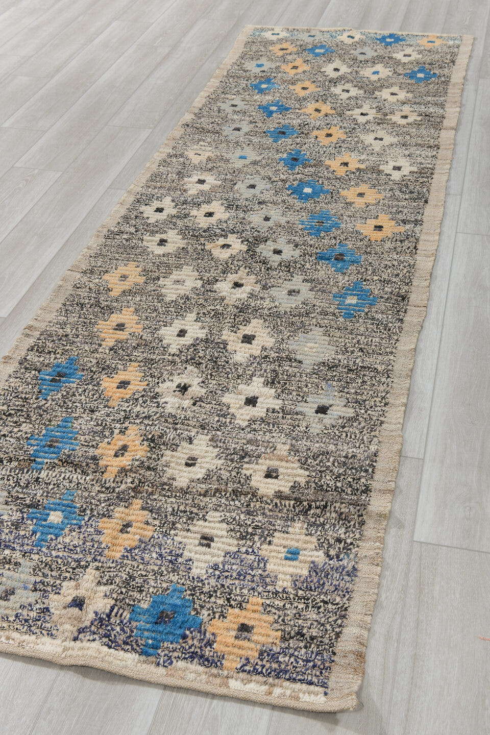 3' x 11' one-of-a-kind handmade vintage Tulu runner rug. Color palette: charcoal, ivory, blue, cream, peach, gray, black