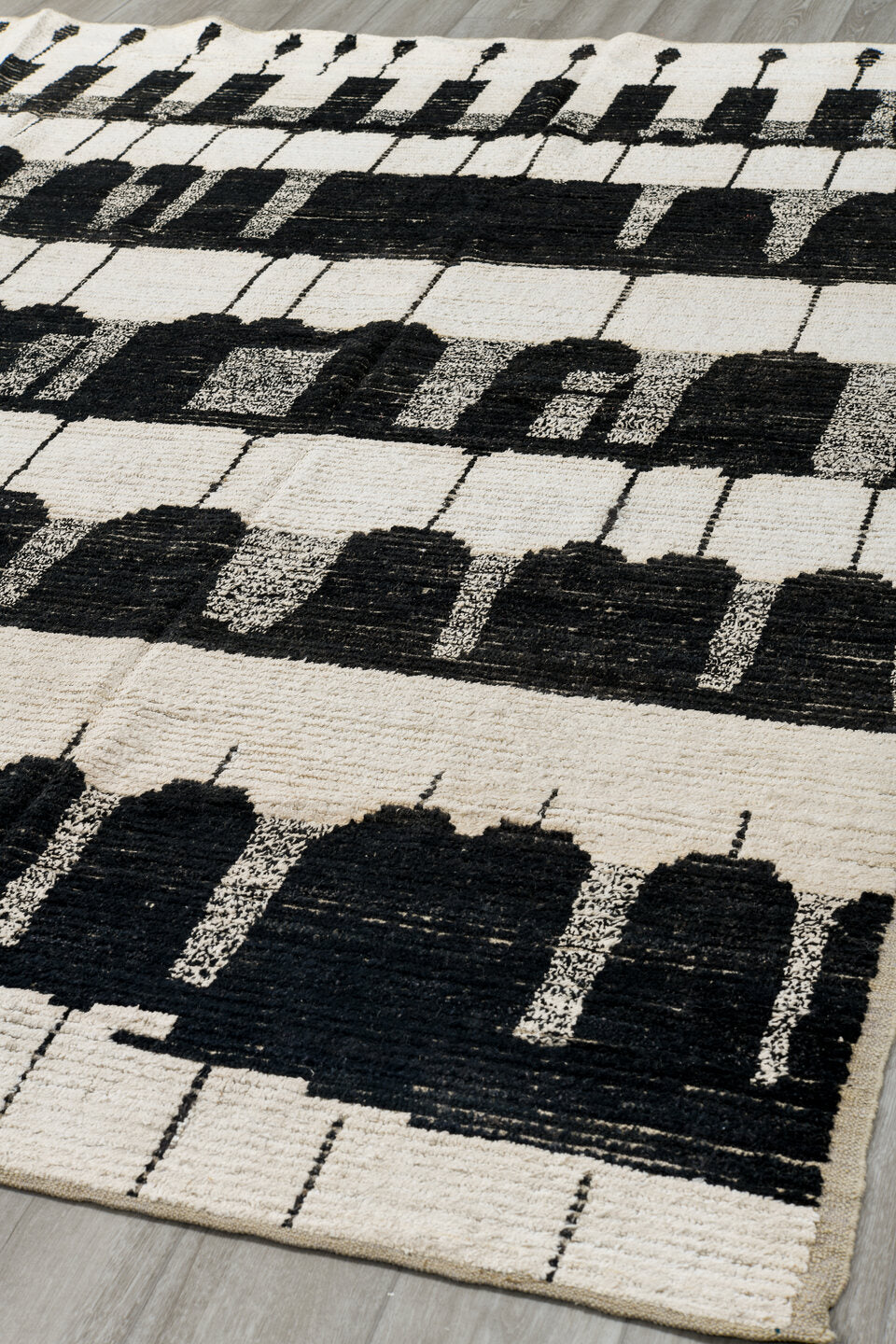 7' x 9' one-of-a-kind handmade vintage Tulu rug. Color palette: ivory, black, charcoal, gray