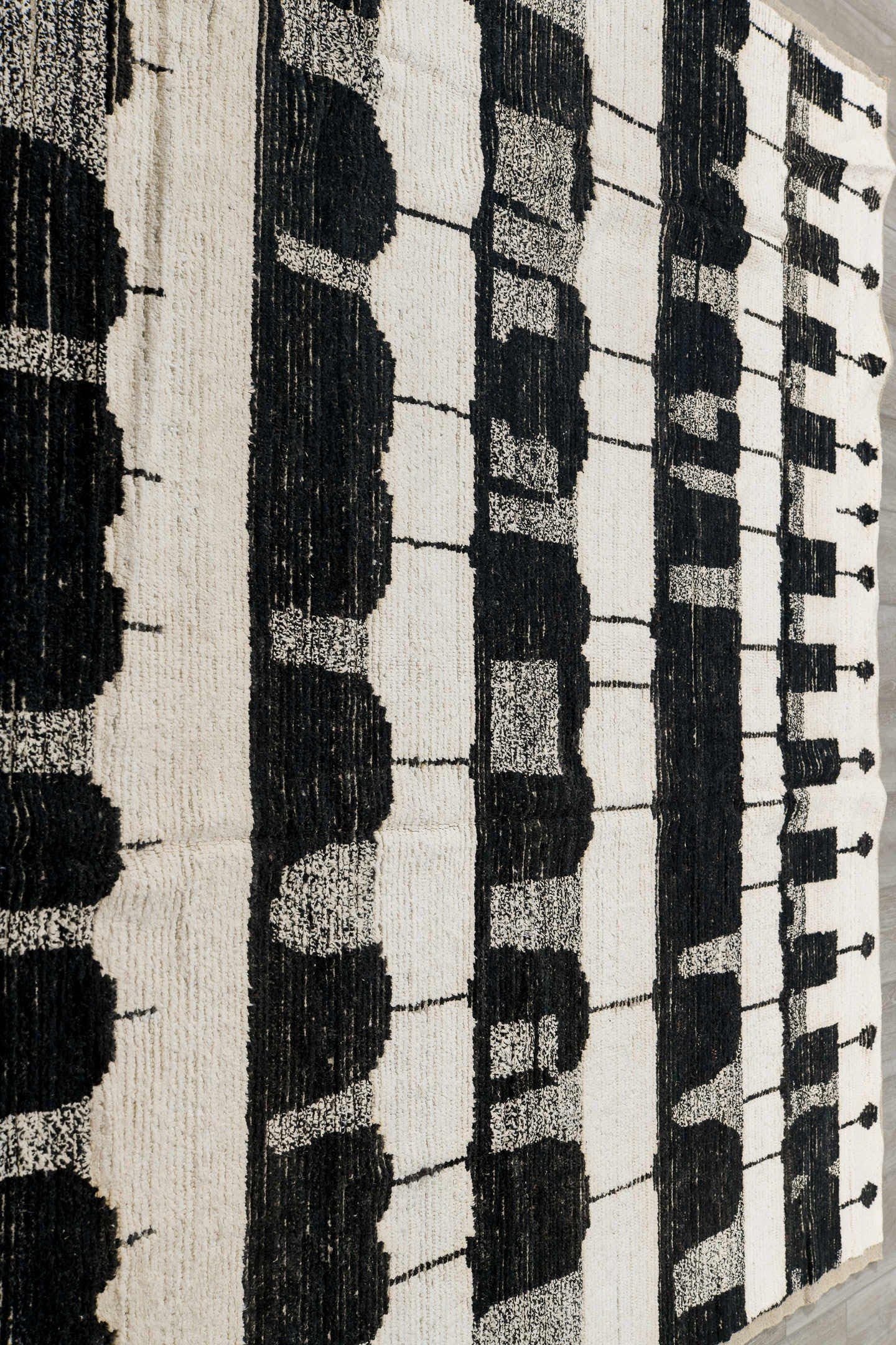 7' x 9' one-of-a-kind handmade vintage Tulu rug. Color palette: ivory, black, charcoal, gray
