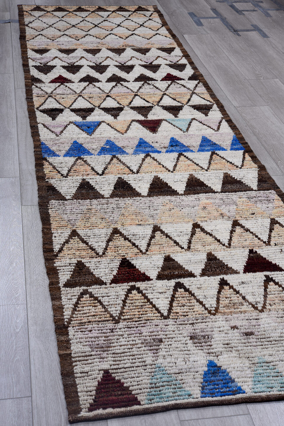 3' x 12' one-of-a-kind handmade vintage Tulu runner rug. Color palette: ivory, brown, charcoal, blush, cobalt, burgundy