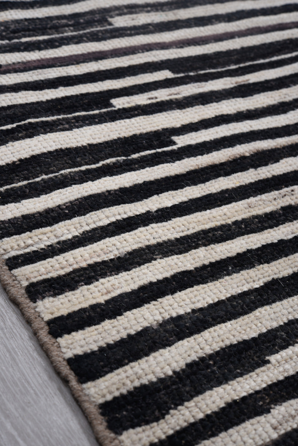 8' x 9' one-of-a-kind handmade vintage Tulu rug. Color palette: ivory, black, charcoal, gray