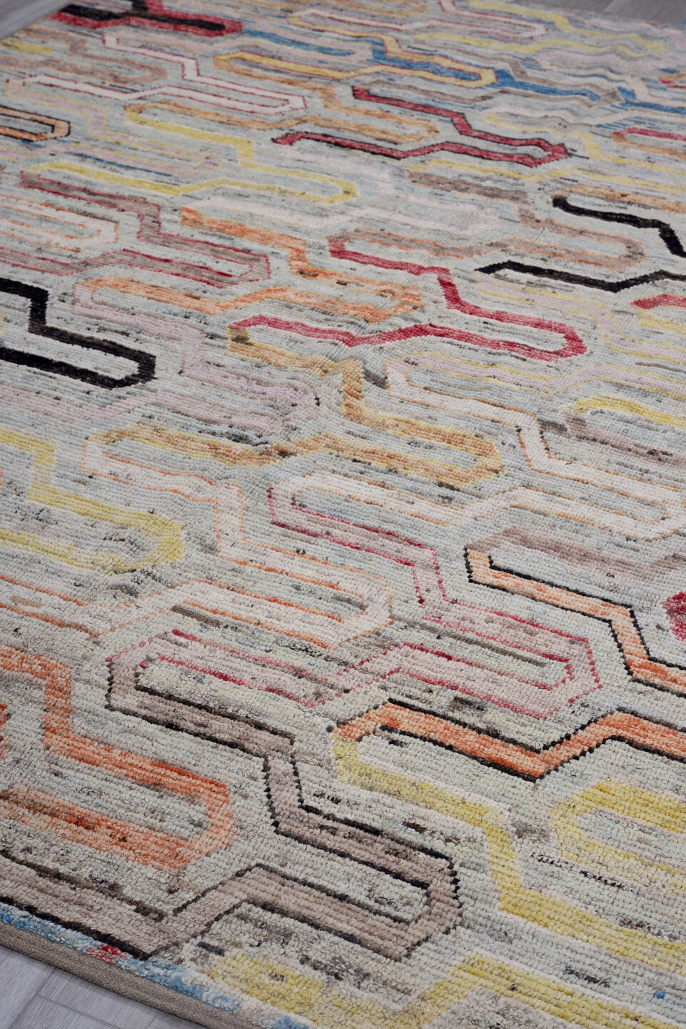 7' x 9' one-of-a-kind handmade vintage Tulu rug. Color palette: ivory, gray, rust, red, yellow, blue, charcoal, peach