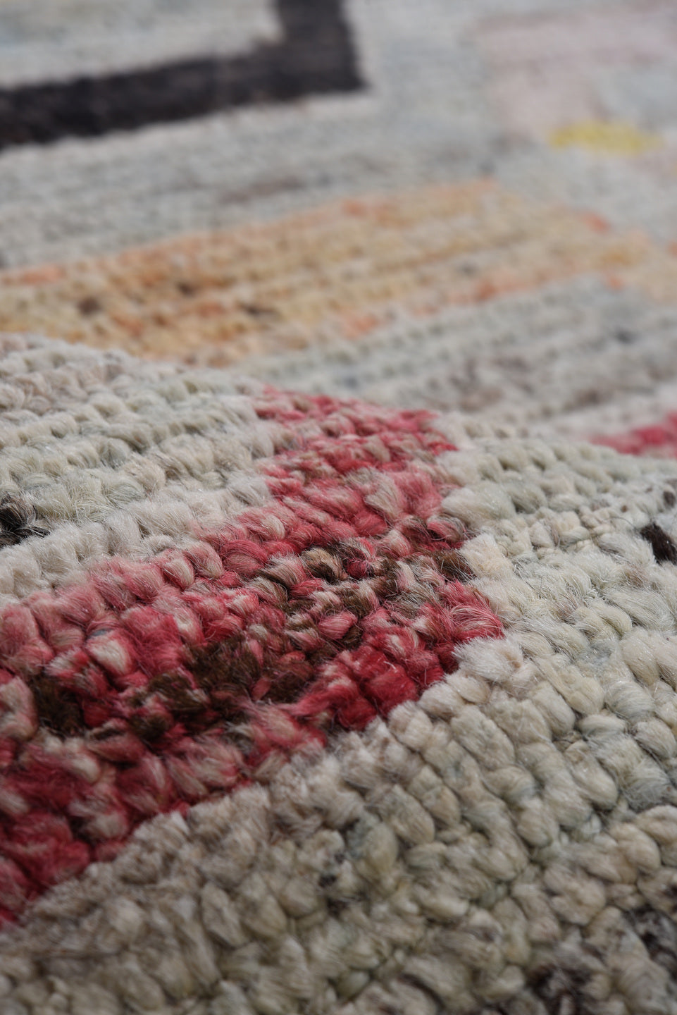 7' x 9' one-of-a-kind handmade vintage Tulu rug. Color palette: ivory, gray, rust, red, yellow, blue, charcoal, peach