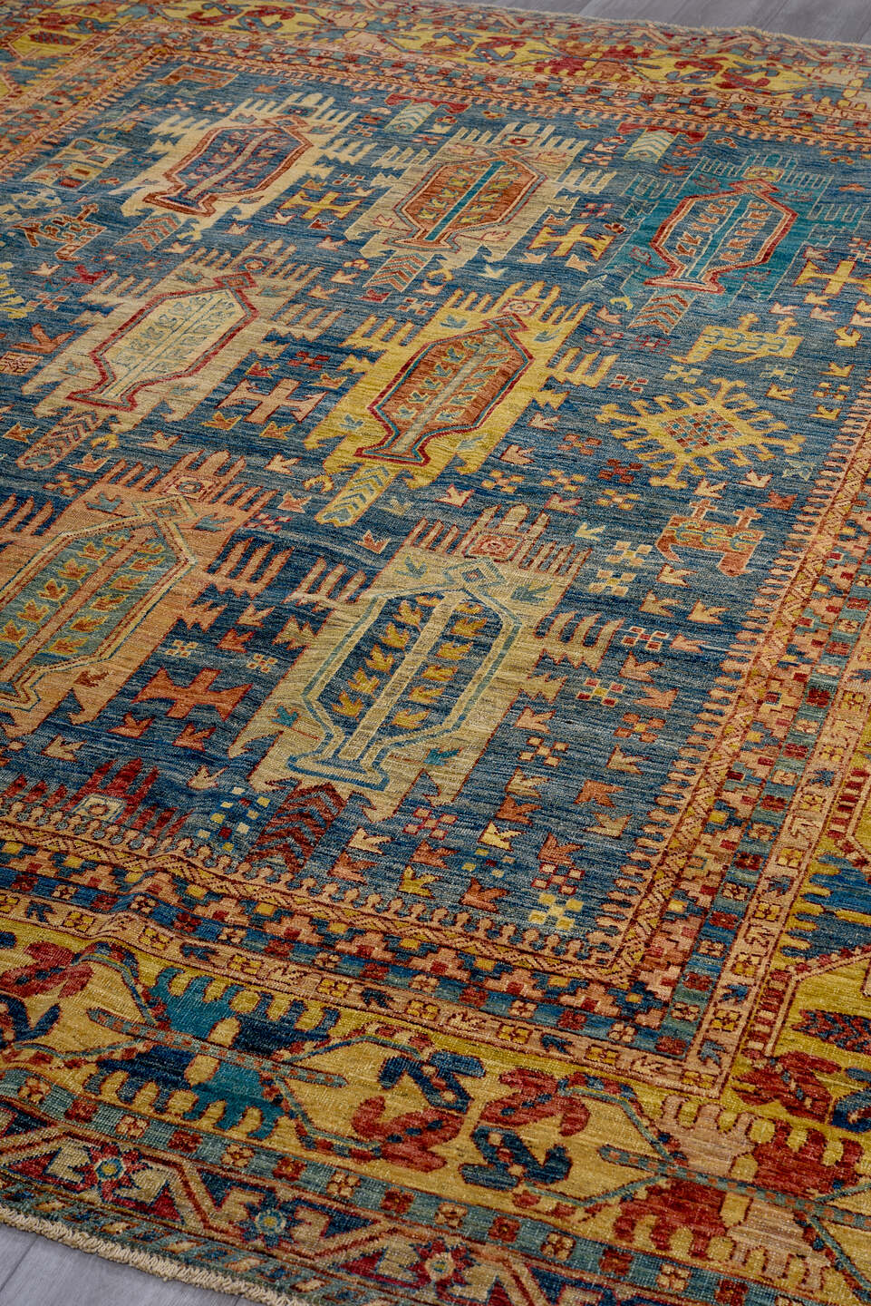 8' x 9' one-of-a-kind handmade vintage Afghan rug. Color palette: blue, gold, rust, ivory, teal, crimson, camel, brown