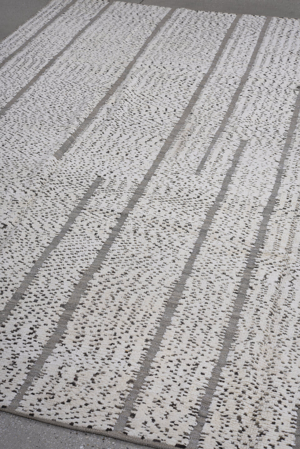 7' x 9' one-of-a-kind handmade vintage Tulu rug. Color palette: ivory, charcoal, taupe, gray, black, beige