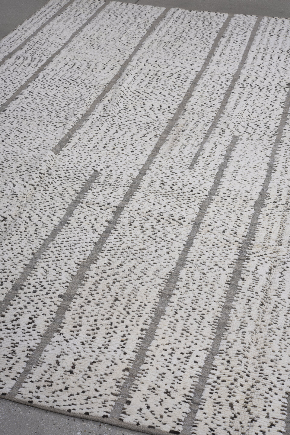 7' x 9' one-of-a-kind handmade vintage Tulu rug. Color palette: ivory, charcoal, taupe, gray, black, beige