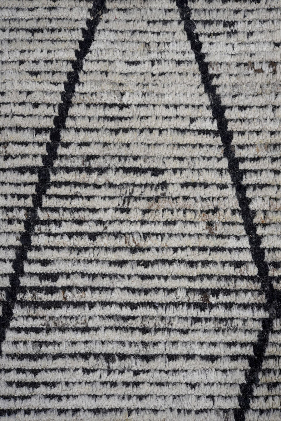 6' x 9' one-of-a-kind handmade vintage Tulu rug. Color palette: ivory, charcoal, black, gray